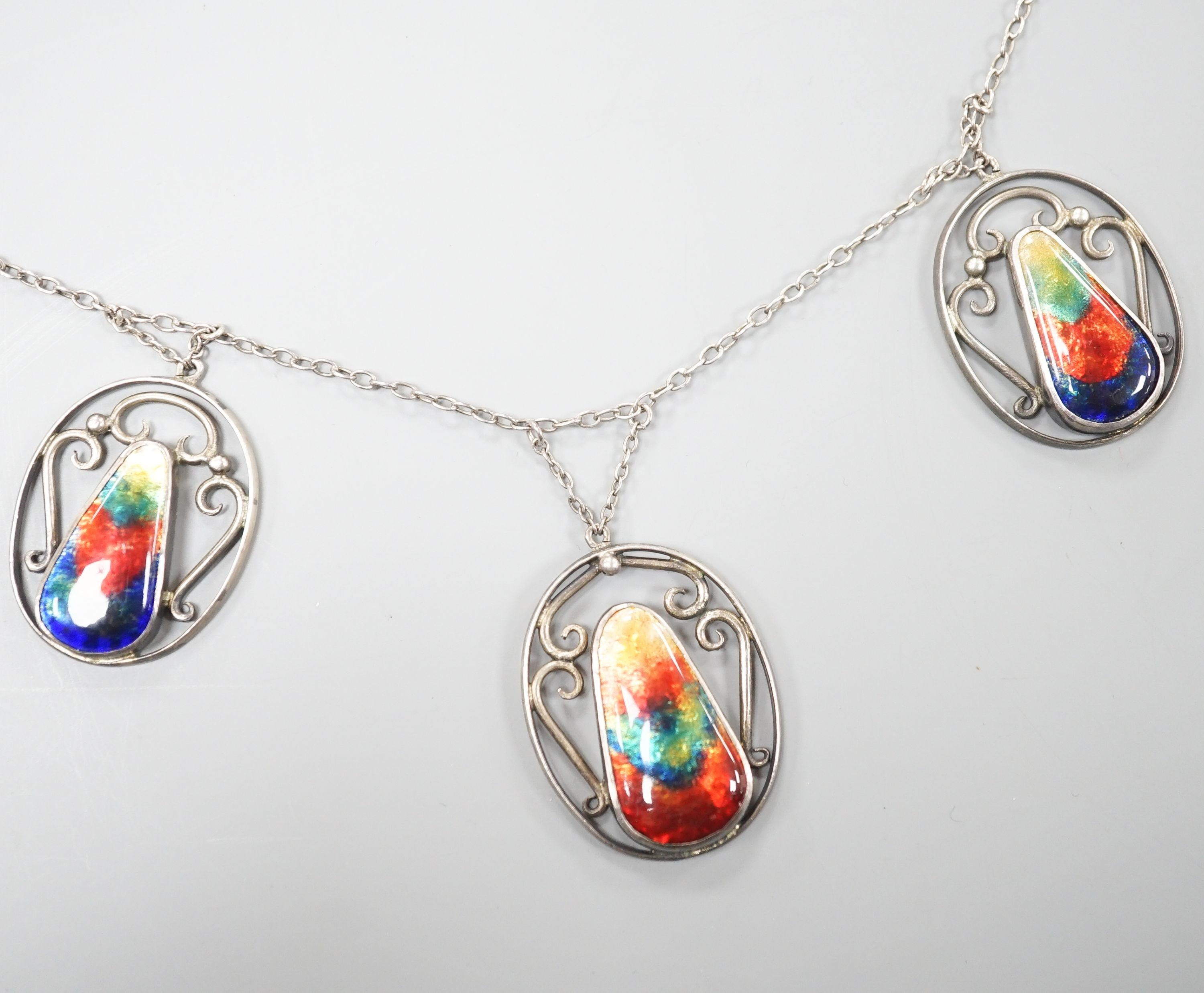 An Arts & Crafts white metal and six stone polychrome enamel set fringe necklace, 52cm.